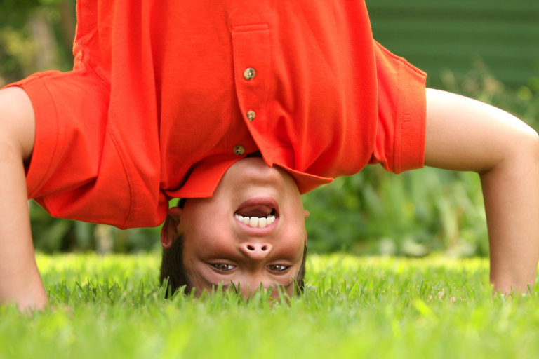 Boy primary aged doing a hand stand