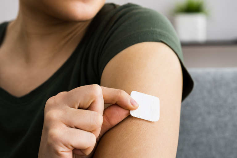 Woman applying a nicotine patch