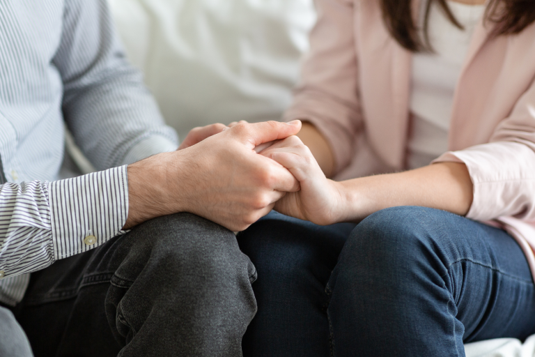 Close up of couple holding hands