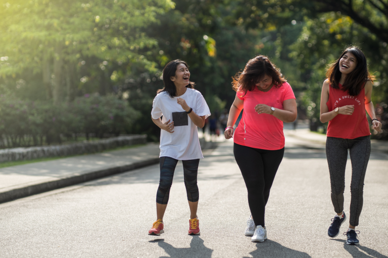 Three teenage girls walking in park