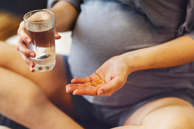 Pregnant lady taking vitamins